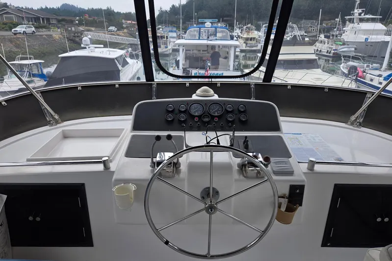 Laissez Faire Yacht Photos Pics Cockpit view of 1993 Ocean Alexander 423 Classicco yacht in a marina setting.