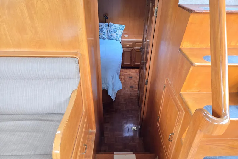 Laissez Faire Yacht Photos Pics Interior of 1993 Ocean Alexander 423 Classicco yacht, featuring wooden stairs and cozy cabin.