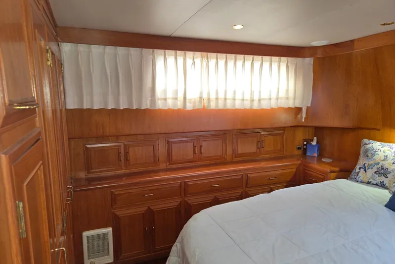 Laissez Faire Yacht Photos Pics Cozy cabin interior of 1993 Ocean Alexander 423 Classicco with wooden cabinetry and bed.