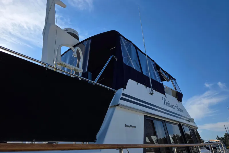 Laissez Faire Yacht Photos Pics Ocean Alexander 423 Classicco yacht, 1993 model, with blue canopy under clear sky.