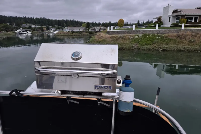 Laissez Faire Yacht Photos Pics Outdoor grill on Ocean Alexander 423 Classicco yacht, 1993, near waterfront homes.