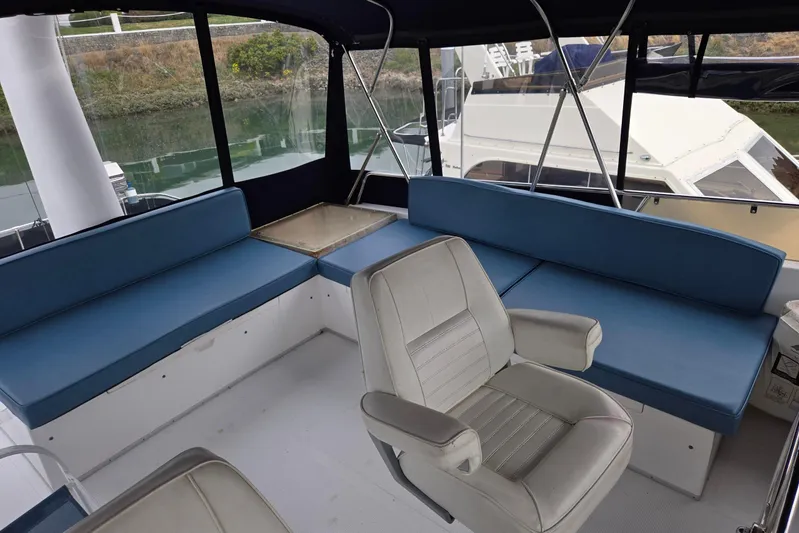 Laissez Faire Yacht Photos Pics Interior of 1993 Ocean Alexander 423 Classicco yacht with blue seating and helm chair.