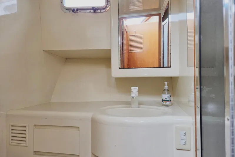 Laissez Faire Yacht Photos Pics Bathroom interior of 1993 Ocean Alexander 423 Classicco yacht, featuring sink and mirror.