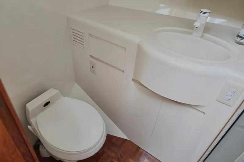 Laissez Faire Yacht Photos Pics Bathroom interior of 1993 Ocean Alexander 423 Classicco yacht, featuring toilet and sink.