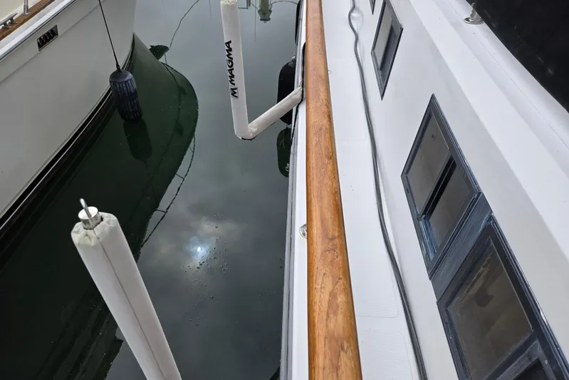 Laissez Faire Yacht Photos Pics 1993 Ocean Alexander 423 Classicco yacht docked, showing deck and water reflection.
