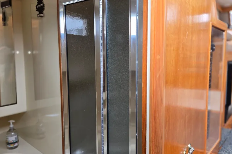 Laissez Faire Yacht Photos Pics Interior view of 1993 Ocean Alexander 423 Classicco yacht, featuring wood cabinetry and modern fixtures.