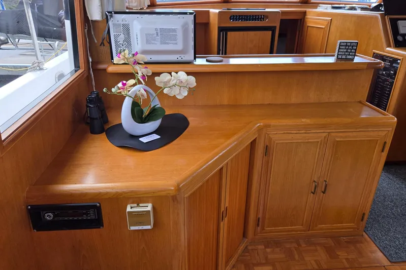Laissez Faire Yacht Photos Pics Interior of 1993 Ocean Alexander 423 Classicco with wooden cabinetry and decorative orchid.