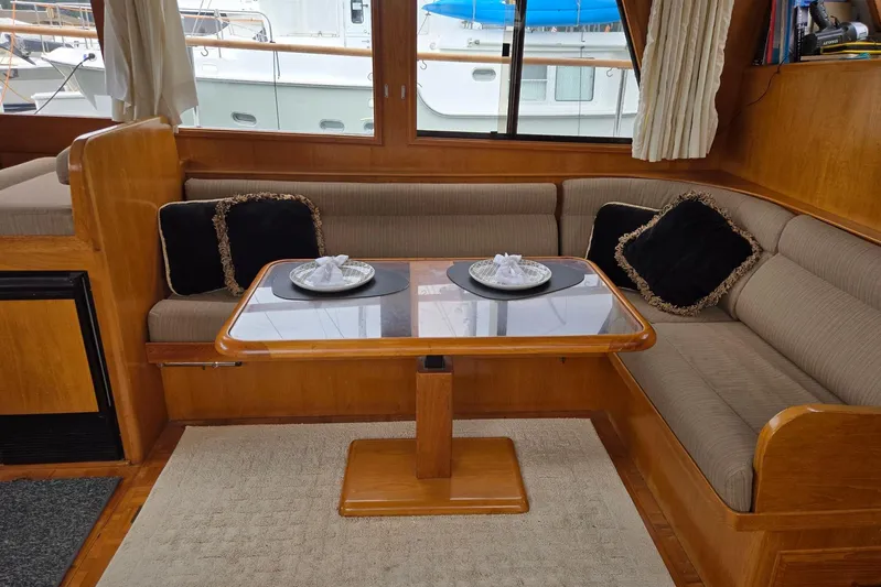 Laissez Faire Yacht Photos Pics Interior of 1993 Ocean Alexander 423 Classicco yacht with cozy seating and elegant table setting.