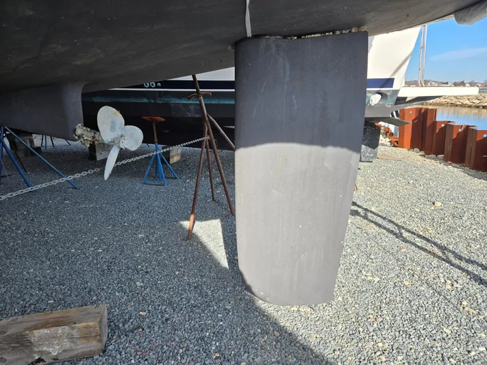 Surprise Yacht Photos Pics Beneteau 49 sailboat keel and propeller, 2007 model, on gravel surface.