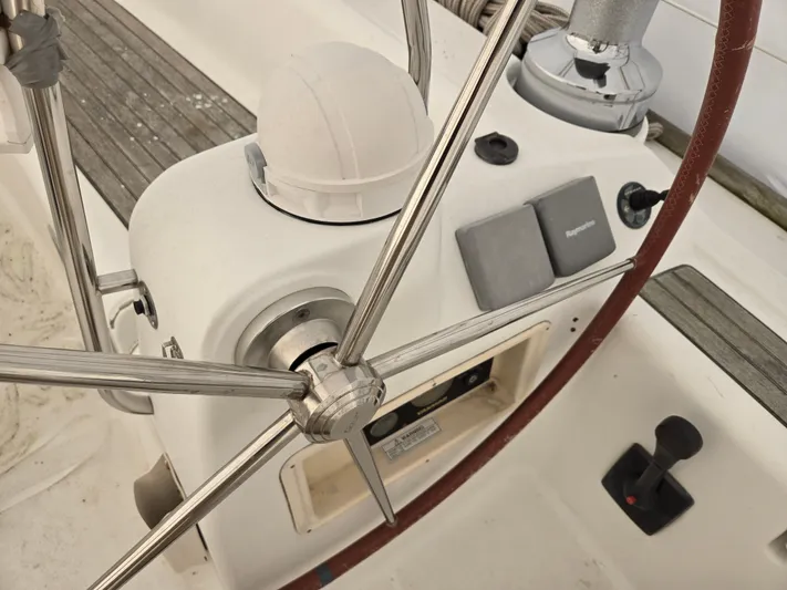 Surprise Yacht Photos Pics Steering wheel and controls of a 2007 Beneteau 49 sailboat cockpit.