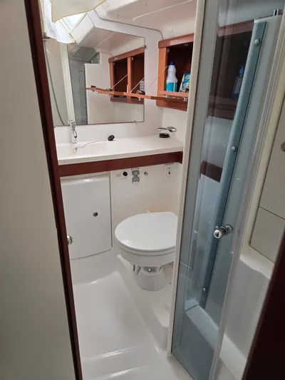 Surprise Yacht Photos Pics 2007 Beneteau 49 yacht bathroom with shower, sink, and storage cabinets.