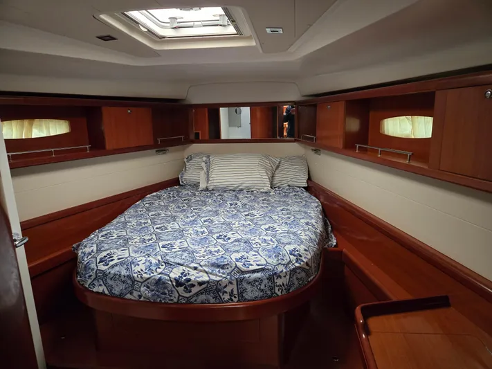 Surprise Yacht Photos Pics Luxurious cabin interior of 2007 Beneteau 49 yacht with cozy bed and wooden finish.