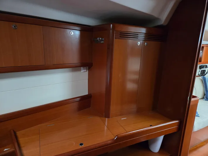 Surprise Yacht Photos Pics Interior of 2007 Beneteau 49 yacht with wooden cabinetry and storage space.