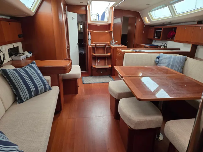 Surprise Yacht Photos Pics Interior of 2007 Beneteau 49 yacht with wood finish and comfortable seating.