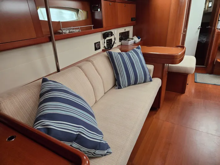 Surprise Yacht Photos Pics Interior of 2007 Beneteau 49 yacht with cozy seating and striped cushions.