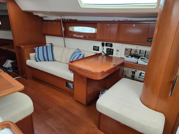 Surprise Yacht Photos Pics Interior of 2007 Beneteau 49 yacht with wooden furnishings and seating area.
