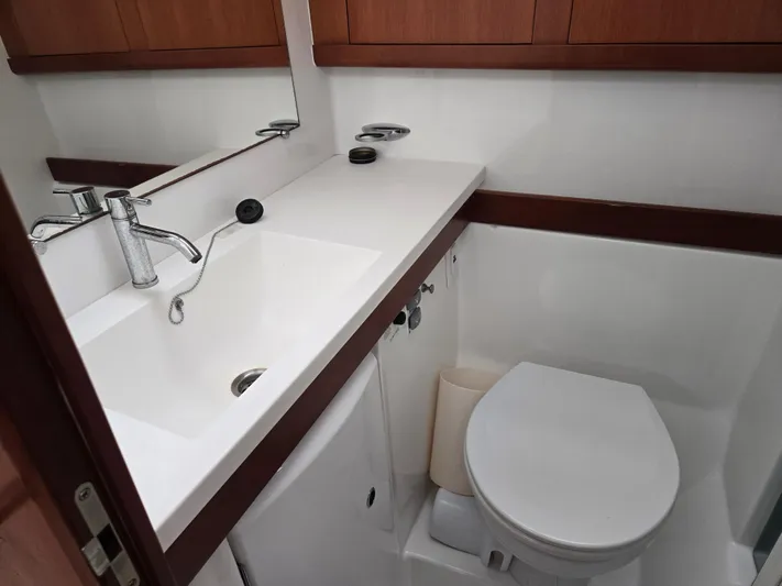 Surprise Yacht Photos Pics Compact bathroom in 2007 Beneteau 49 yacht with sink and toilet.