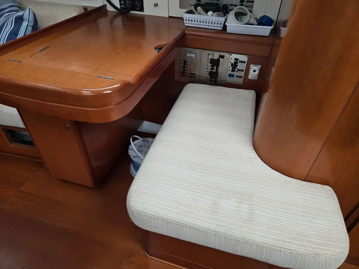 Surprise Yacht Photos Pics Interior of 2007 Beneteau 49 yacht with wooden table and cushioned seating.