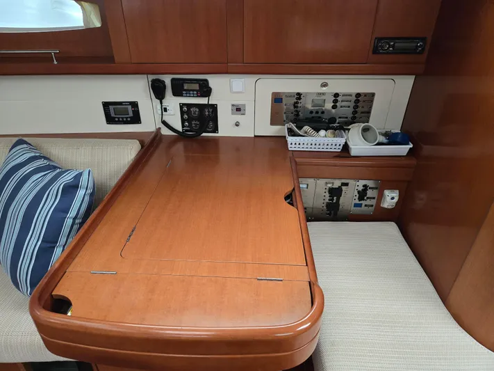 Surprise Yacht Photos Pics Interior of 2007 Beneteau 49 yacht with navigation station and seating area.