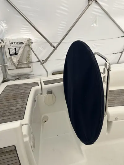 Surprise Yacht Photos Pics 2007 Beneteau 49 yacht cockpit with covered steering wheel and teak flooring.