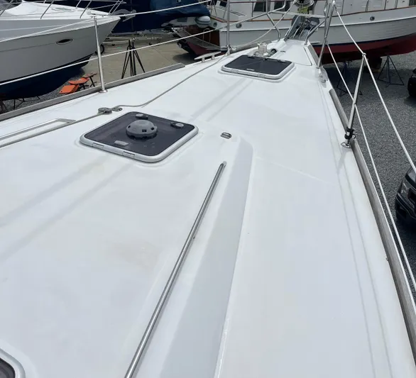 Surprise Yacht Photos Pics Deck view of a 2007 Beneteau 49 sailboat, showcasing hatches and rigging.