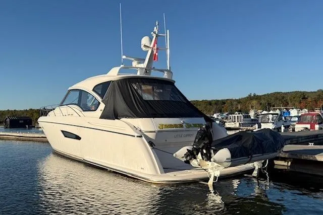 Jesse James Yacht Photos Pics 2011 Tiara Yachts 5800 Sovran docked at marina, rear view with clear sky.