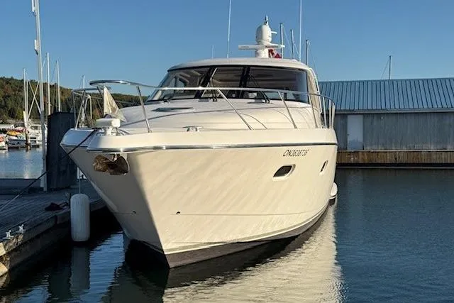 Jesse James Yacht Photos Pics 2011 Tiara Yachts 5800 Sovran docked in a marina under clear skies.