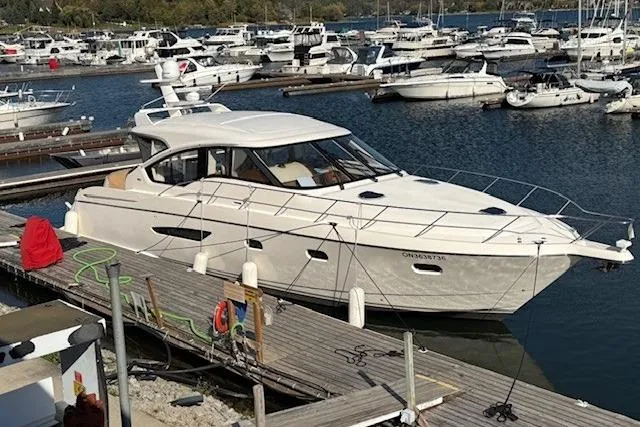 Jesse James Yacht Photos Pics 2011 Tiara Yachts 5800 Sovran docked in a marina with multiple boats.