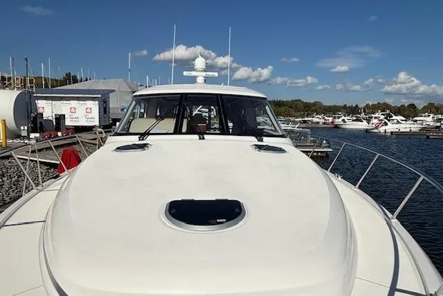 Jesse James Yacht Photos Pics 2011 Tiara Yachts 5800 Sovran docked at a marina under a clear blue sky.