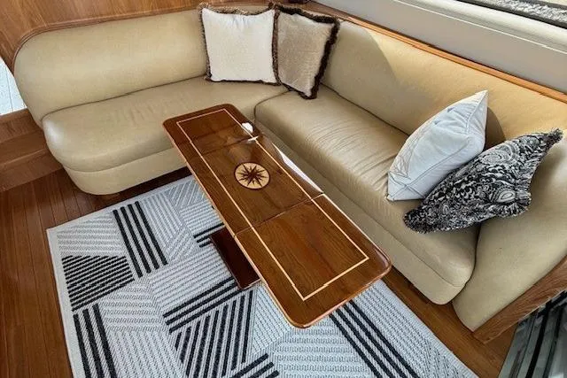 Jesse James Yacht Photos Pics Luxurious interior of 2011 Tiara Yachts 5800 Sovran with elegant seating and wooden table.