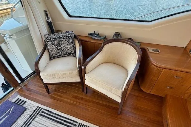 Jesse James Yacht Photos Pics Interior of 2011 Tiara Yachts 5800 Sovran with elegant seating and wooden flooring.