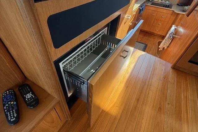 Jesse James Yacht Photos Pics Open drawer in 2011 Tiara Yachts 5800 Sovran kitchen with wooden flooring.