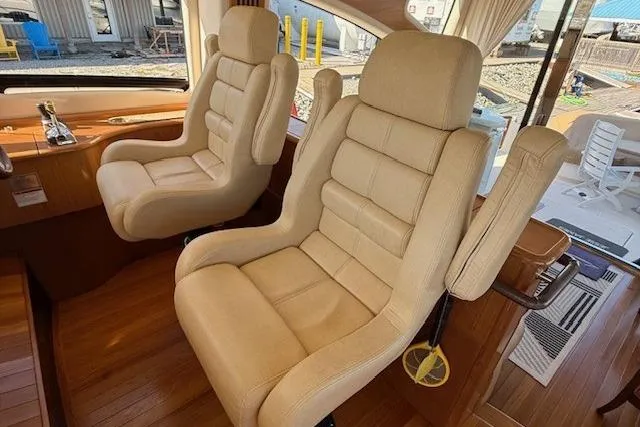 Jesse James Yacht Photos Pics Luxurious interior seating of 2011 Tiara Yachts 5800 Sovran with beige leather chairs.