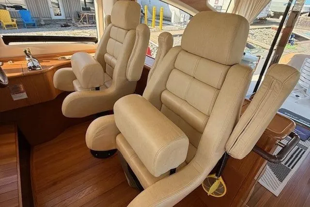 Jesse James Yacht Photos Pics Luxurious beige seating in 2011 Tiara Yachts 5800 Sovran interior, showcasing comfort and elegance.