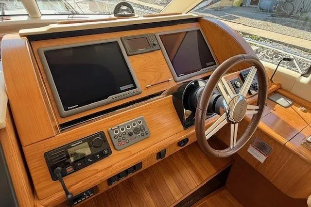 Jesse James Yacht Photos Pics Helm of 2011 Tiara Yachts 5800 Sovran with dual screens and wooden finish.