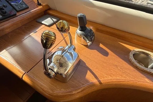 Jesse James Yacht Photos Pics Control panel of 2011 Tiara Yachts 5800 Sovran with polished levers and wooden finish.