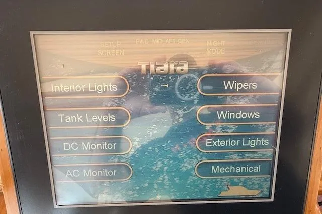 Jesse James Yacht Photos Pics Touchscreen control panel of a 2011 Tiara Yachts 5800 Sovran, displaying various system options.