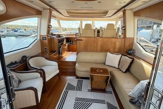 Jesse James Yacht Photos Pics Luxurious interior of 2011 Tiara Yachts 5800 Sovran with elegant seating and scenic windows.