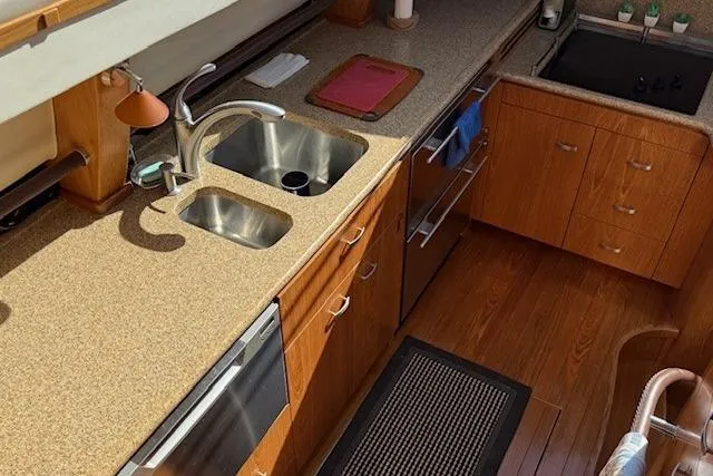 Jesse James Yacht Photos Pics 2011 Tiara Yachts 5800 Sovran kitchen with wood cabinetry, dual sinks, and modern appliances.