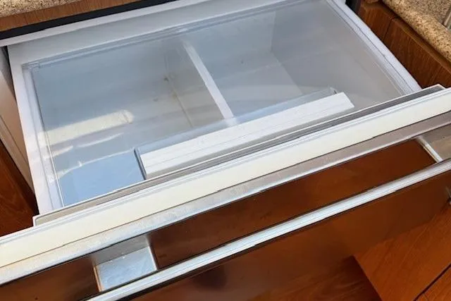 Jesse James Yacht Photos Pics Open drawer in 2011 Tiara Yachts 5800 Sovran, showcasing sleek interior design.