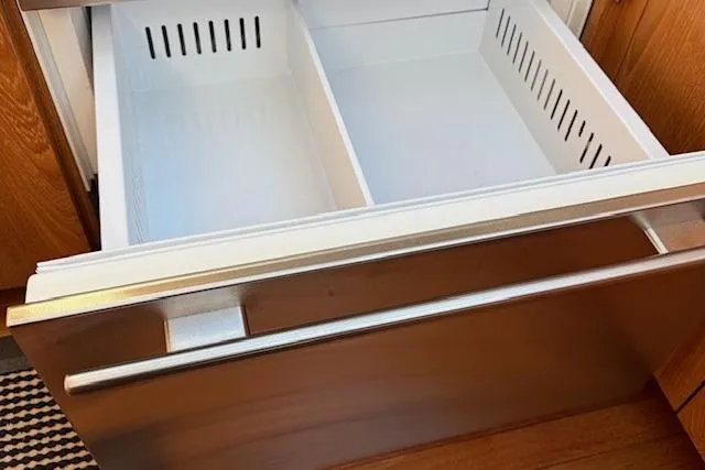 Jesse James Yacht Photos Pics Open drawer in 2011 Tiara Yachts 5800 Sovran, showcasing storage space.