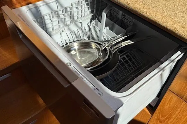 Jesse James Yacht Photos Pics Open dishwasher with cookware inside on a Tiara Yachts 5800 Sovran, 2011 model.