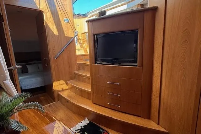 Jesse James Yacht Photos Pics Interior of 2011 Tiara Yachts 5800 Sovran with wooden cabinetry and built-in TV.