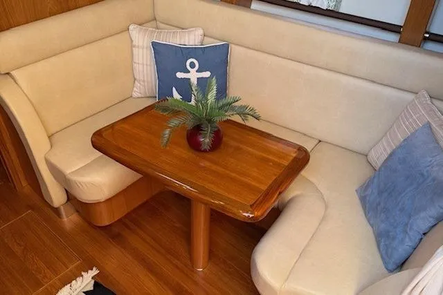 Jesse James Yacht Photos Pics 2011 Tiara Yachts 5800 Sovran interior with cozy seating and wooden table.