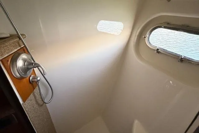 Jesse James Yacht Photos Pics Shower area in 2011 Tiara Yachts 5800 Sovran with porthole and modern fixtures.