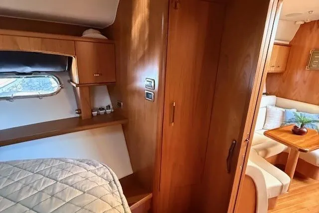 Jesse James Yacht Photos Pics Interior of 2011 Tiara Yachts 5800 Sovran, featuring cozy cabin and dining area.