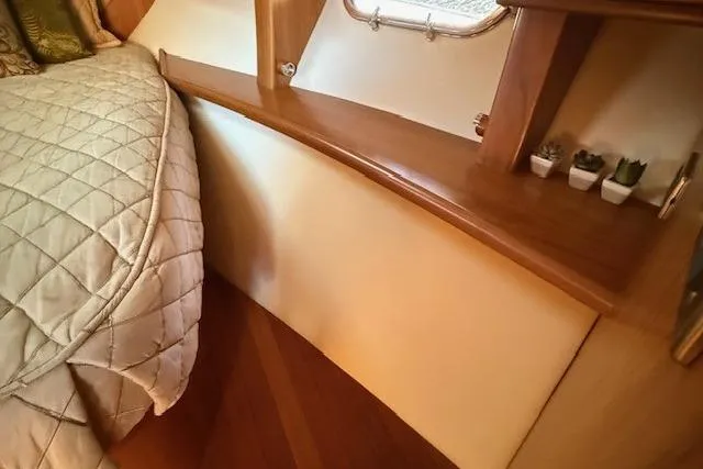 Jesse James Yacht Photos Pics Luxurious cabin interior of 2011 Tiara Yachts 5800 Sovran with elegant bedding and wood accents.