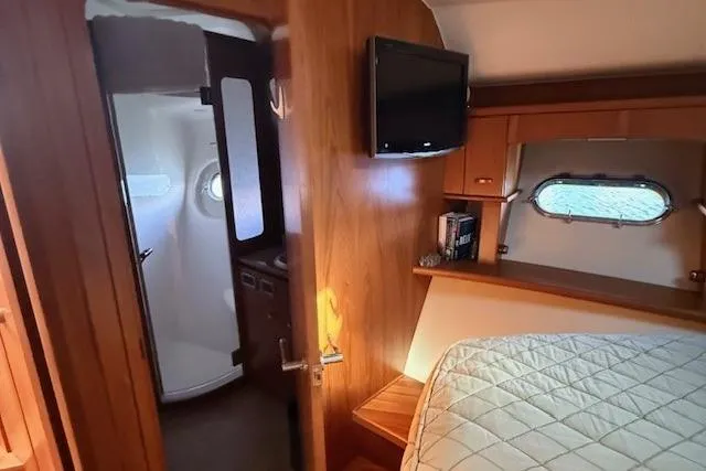 Jesse James Yacht Photos Pics Interior of 2011 Tiara Yachts 5800 Sovran, featuring cozy cabin and bathroom.