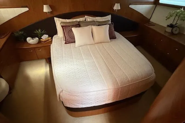 Jesse James Yacht Photos Pics Luxurious bedroom interior of 2011 Tiara Yachts 5800 Sovran with elegant bedding.