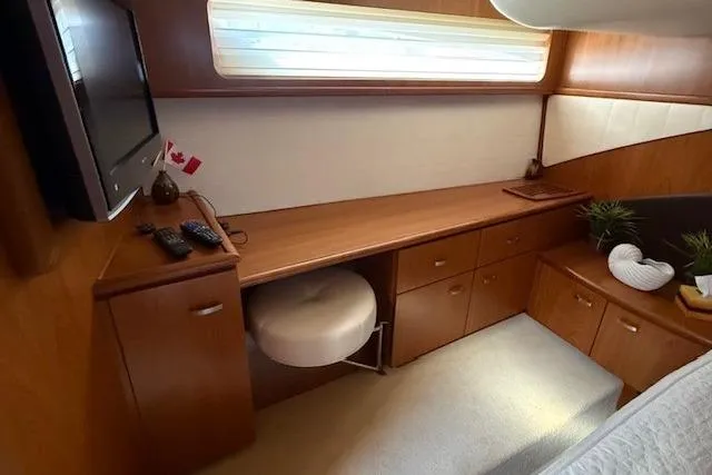 Jesse James Yacht Photos Pics Luxurious interior of 2011 Tiara Yachts 5800 Sovran with elegant wood cabinetry.